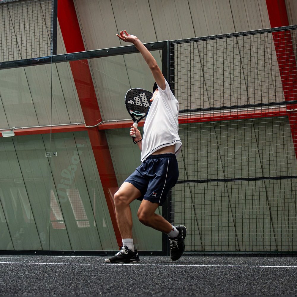Bandeja eseguita da un giovane atleta durante un allenamento di padel agonistico a Treviso